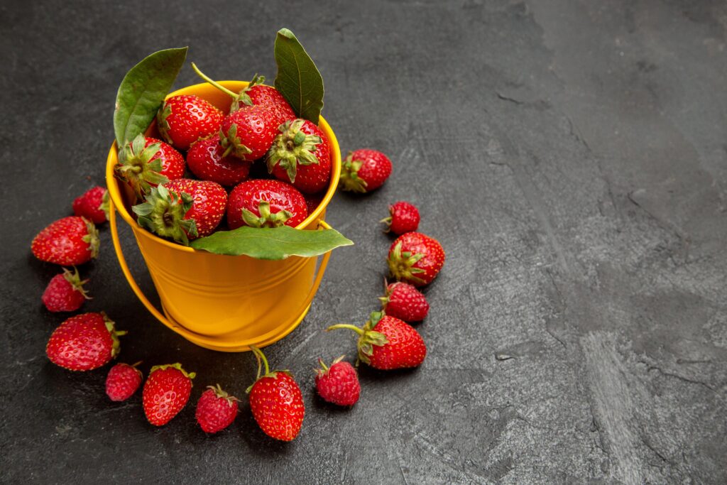 front view fresh red strawberries lined dark background (1)