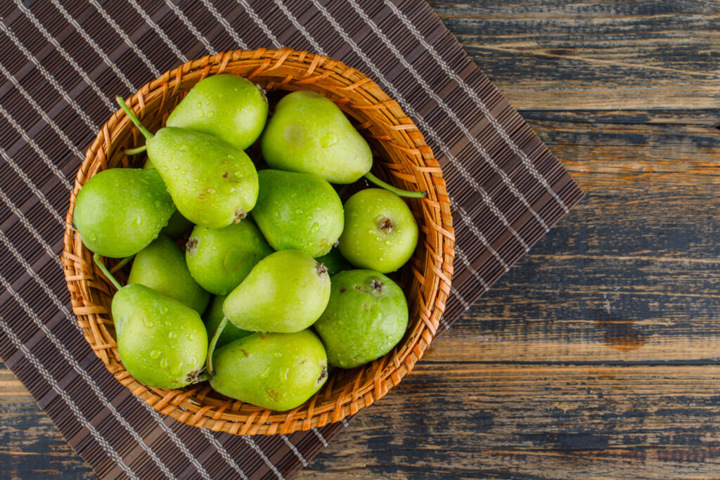 pears basket flat lay wooden placemat background (2)